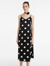 a lady in black acetate polka dots printed slip midi dress